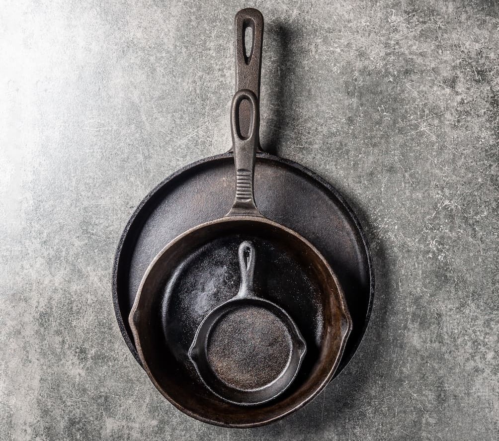cast-iron-pans-or-skillets-on-grey-background-2025-02-11-15-14-32-utc (1)